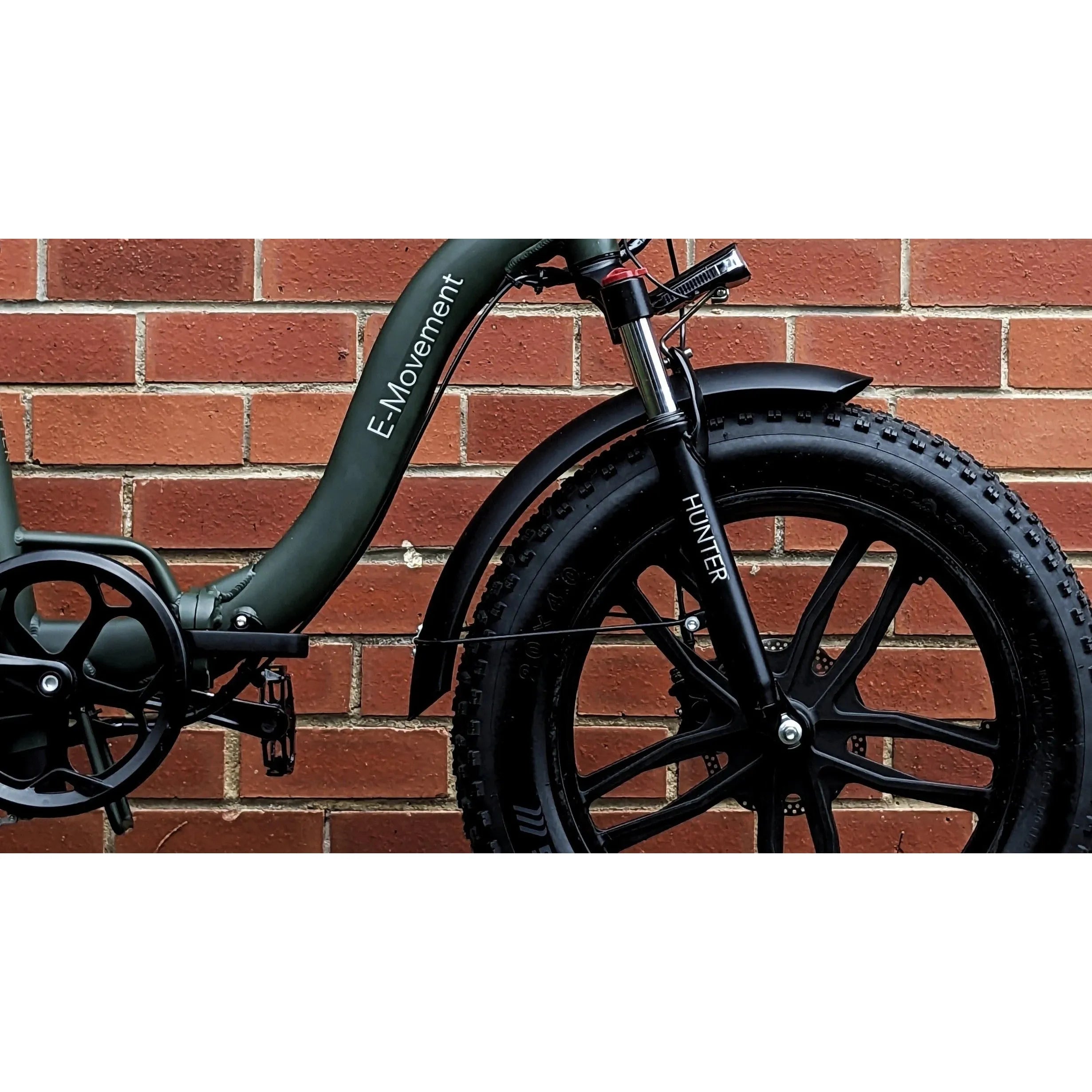 E-MOVEMENT Hunter Extreme Folding Fat Tyre Electric Bike 350W/500W in front of wall
